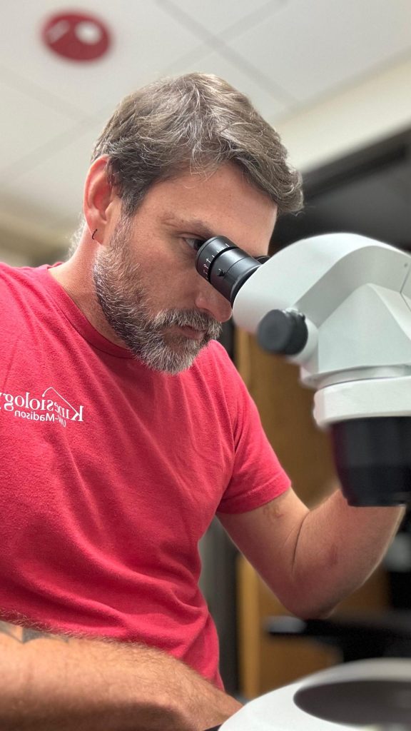student looking through a microscope