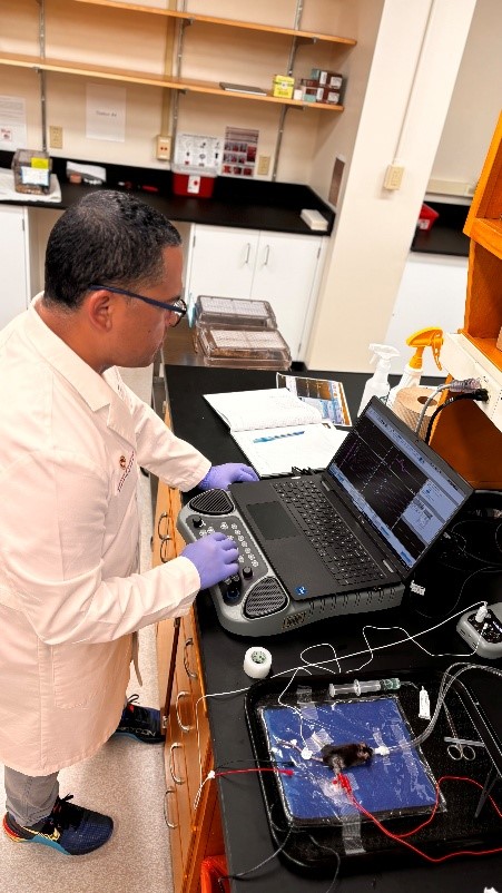 Doctor Padilla looking at a laptop