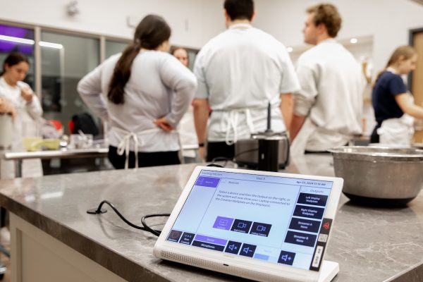 an ipad recording data as students work in a test kitchen