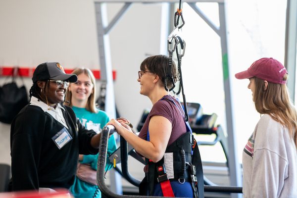 students work with clients for the adapted fitness program