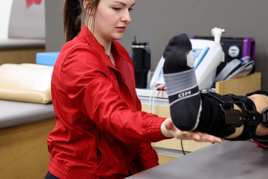 student works with an athletic on mobillity
