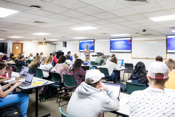 classroom full of students at laptops