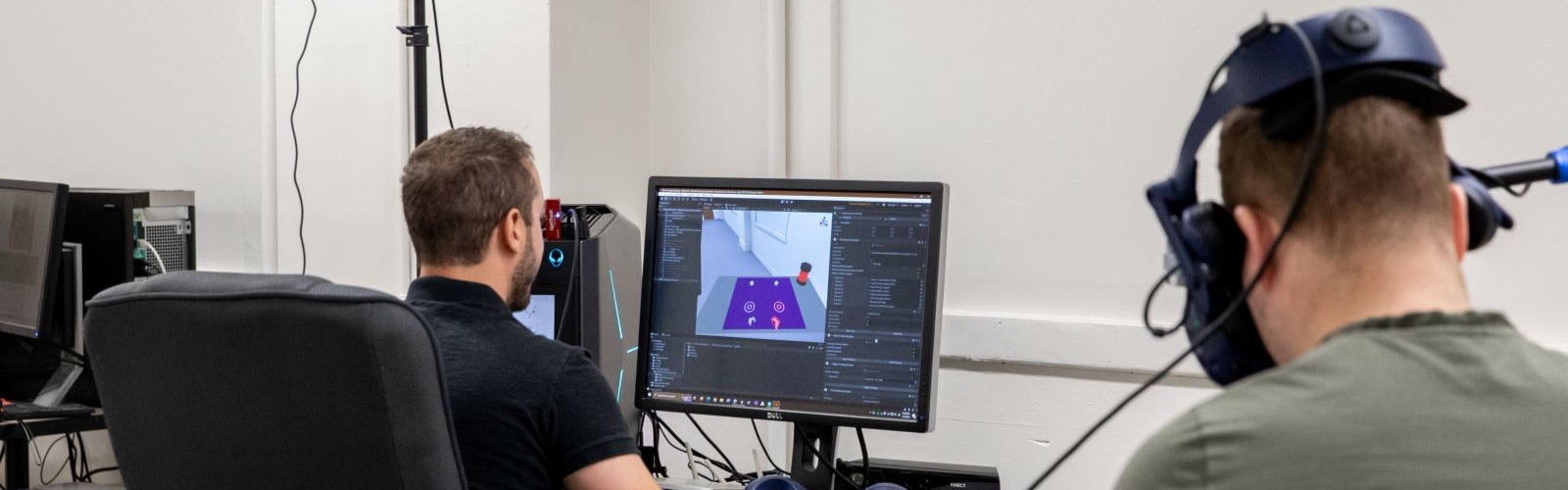 Graduate students using virtual reality in motor control lab.